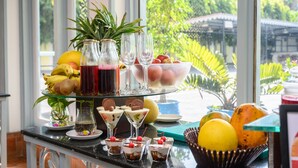A fruit and dessert display with a tropical view. - Sinclairs Siliguri (Siliguri)
