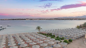 On the beach, sun-loungers, beach umbrellas, beach towels