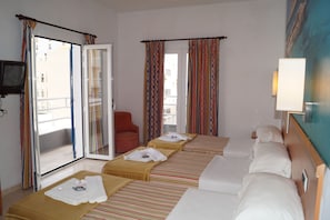 A hotel room with two beds, a TV, a chair, and a balcony with curtains.