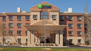 A brick building with a large entrance and a sign for Holiday Inn Express. - Holiday Inn Express & Suites Lubbock West by IHG (Lubbock)