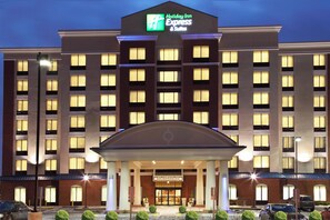 A Holiday Inn Express & Suites building with a central entrance, multiple floors, and a brick facade. - Holiday Inn Express Hotel & Suites Columbus Univ Area - Osu by IHG (Columbus)