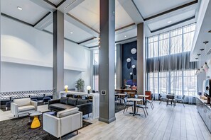 A spacious lobby with seating areas, a reception desk, and large windows providing natural light. - Holiday Inn Express Hotel & Suites Columbus Univ Area - Osu by IHG (Columbus)