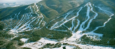 A mountainous landscape with ski trails and a small settlement.