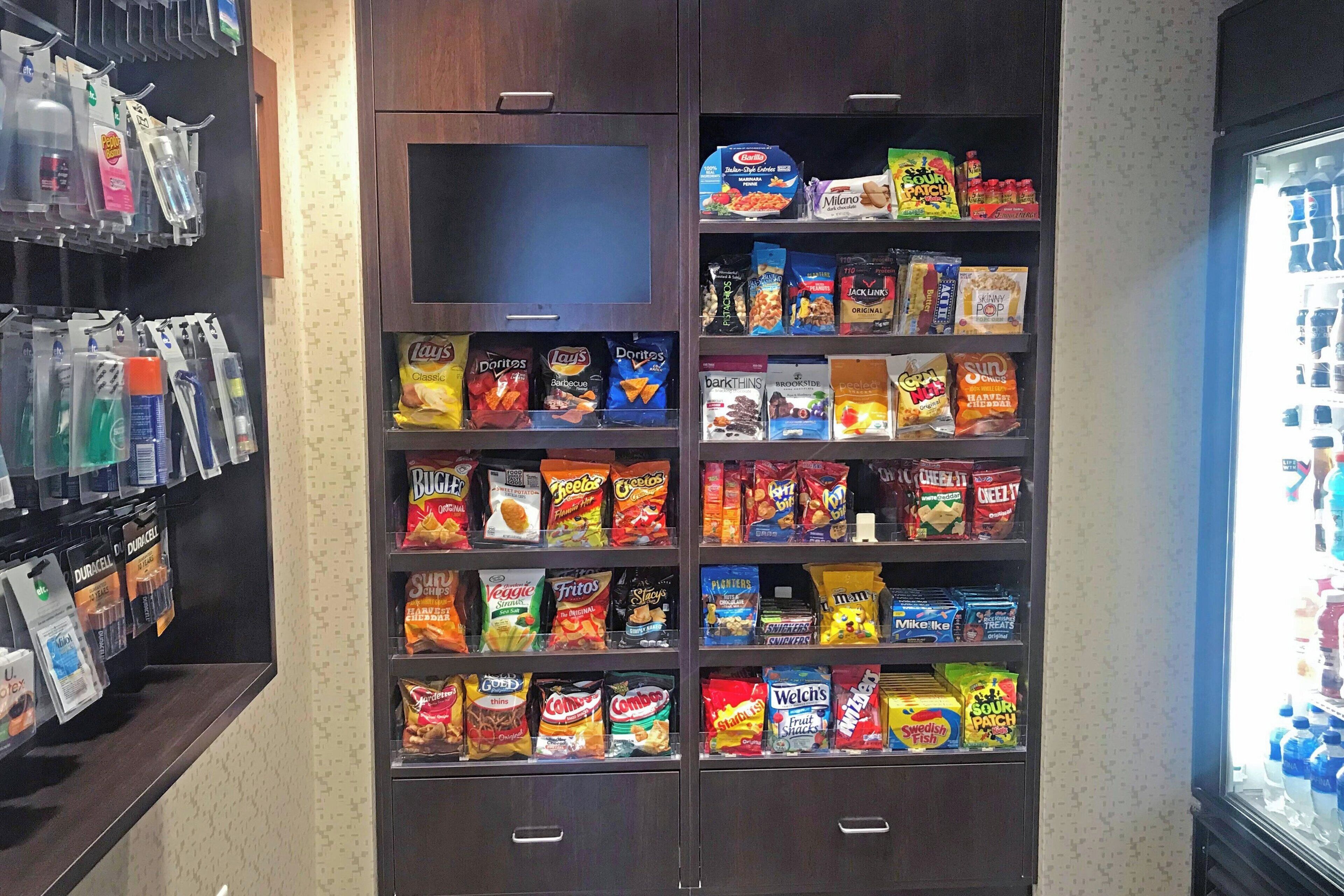 A snack display with various brands and types of chips and snacks.