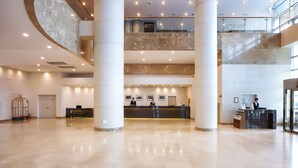 A spacious lobby with a reception desk, multiple floors, and a high ceiling. - Orakai Songdo Park Hotel, BW Premier Collection (Incheon)