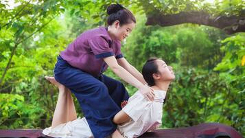 Guests can unwind in a serene natural setting surrounded by lush greenery and trees.