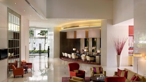 A spacious lobby with a reception area, seating arrangements, and a large mirror. - Marriott Executive Apartments Sukhumvit Park, Bangkok (Bangkok)