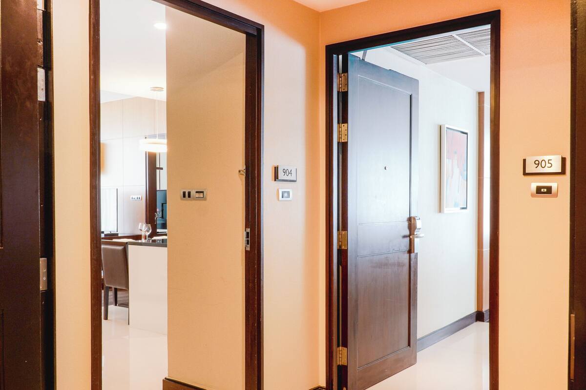 A hotel corridor with doors numbered 904 and 905, leading to rooms.