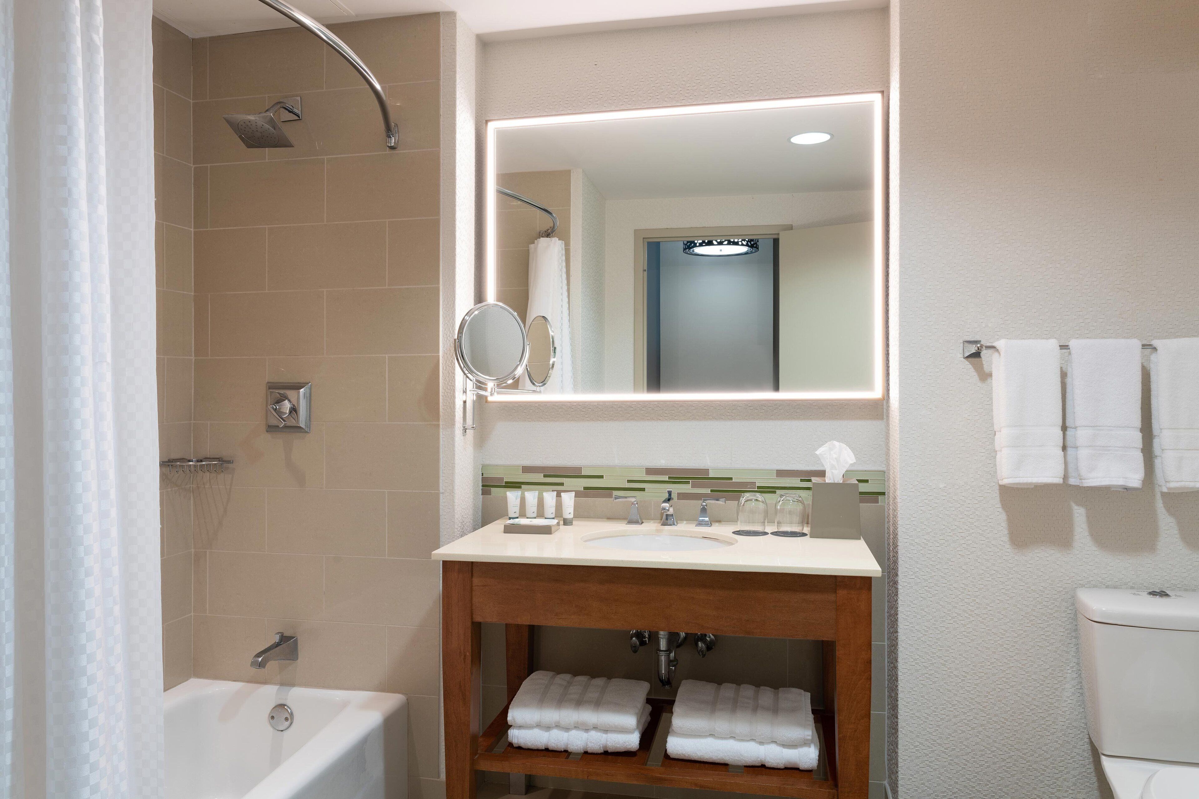 combined shower/bathtub, designer toiletries, hair dryer, bathrobes