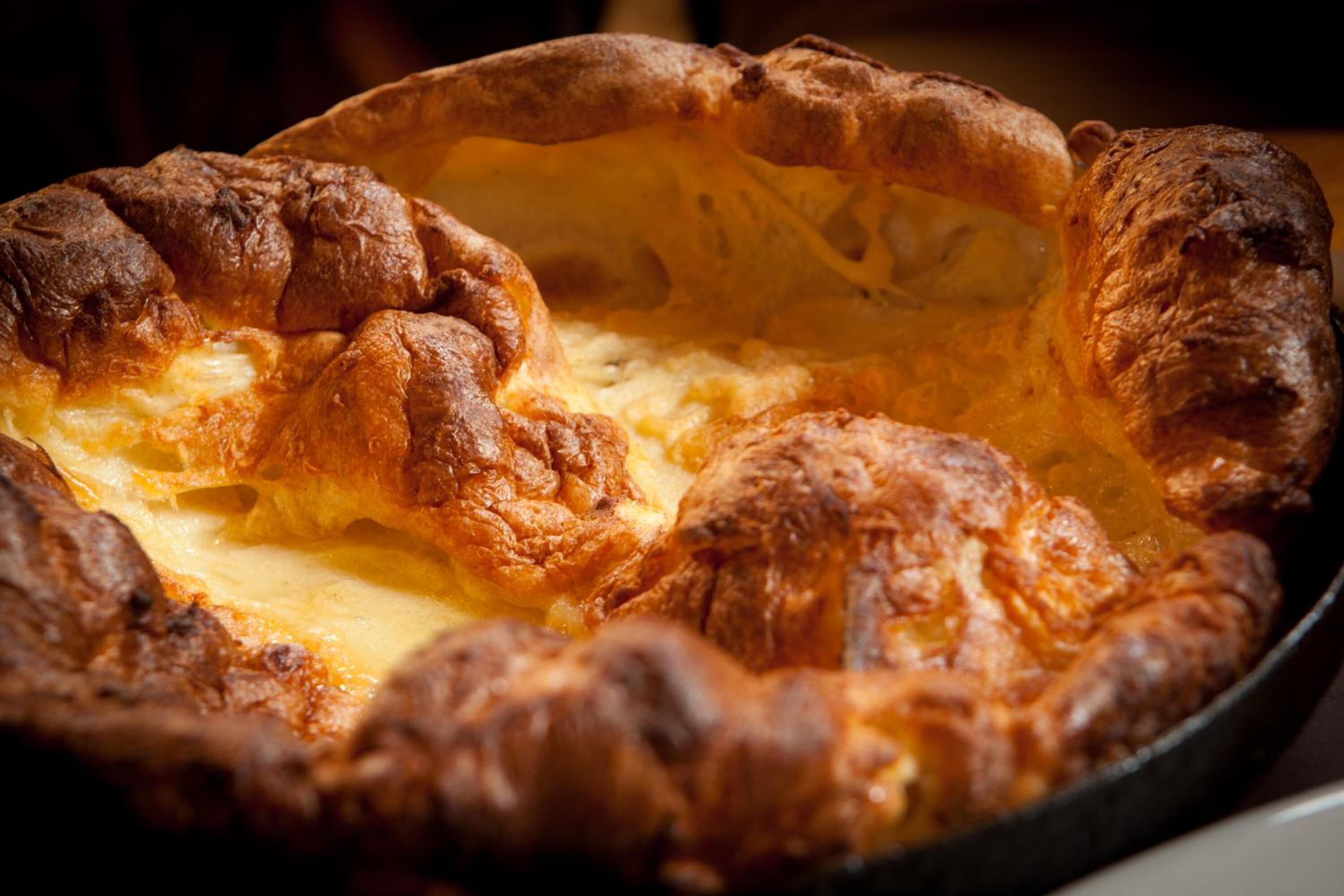 A Yorkshire pudding in a cast iron dish.
