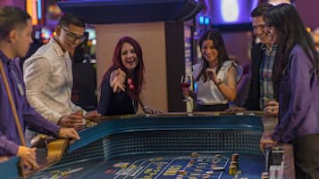 Experience the excitement of gaming at this vibrant casino, where slot machines and a roulette wheel offer endless entertainment options.