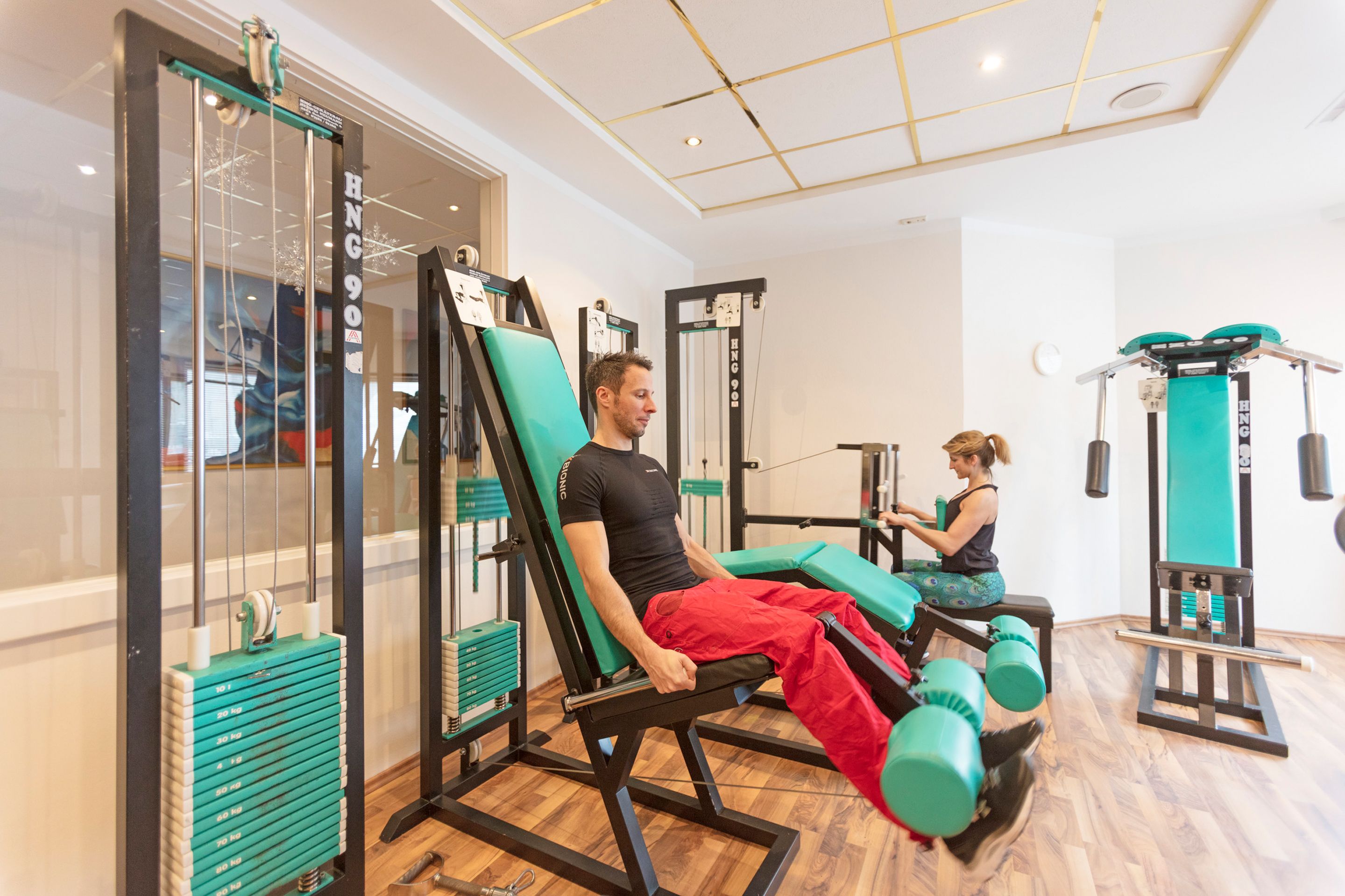 A gym with exercise equipment, including weight machines and a rowing machine.