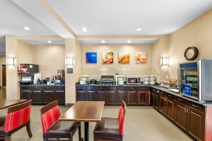 Een hotelkeuken met een buffet, een zithoek en een klok aan de muur.
