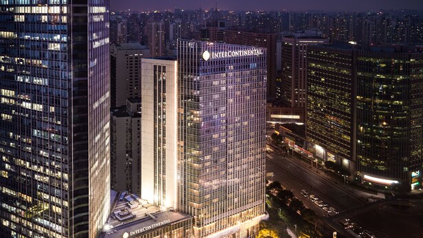 A high-rise building with a glass facade and the name "INTERCONTINENTAL" prominently displayed. - InterContinental Shanghai Jing’ An by IHG (Shanghai)