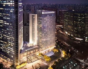 A high-rise building with a glass facade and the name "INTERCONTINENTAL" prominently displayed. - InterContinental Shanghai Jing’ An by IHG (Shanghai)