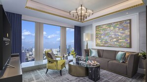 A modern hotel room with a city view, a large window, a sofa, a yellow armchair, a round coffee table, and a chandelier. - InterContinental Shanghai Jing’ An by IHG (Shanghai)