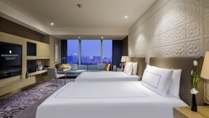 A hotel room with two beds, a TV, a desk, and a view of the cityscape. - InterContinental Shanghai Jing’ An by IHG (Shanghai)