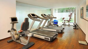 A gym with treadmills, an elliptical, and a weight machine.