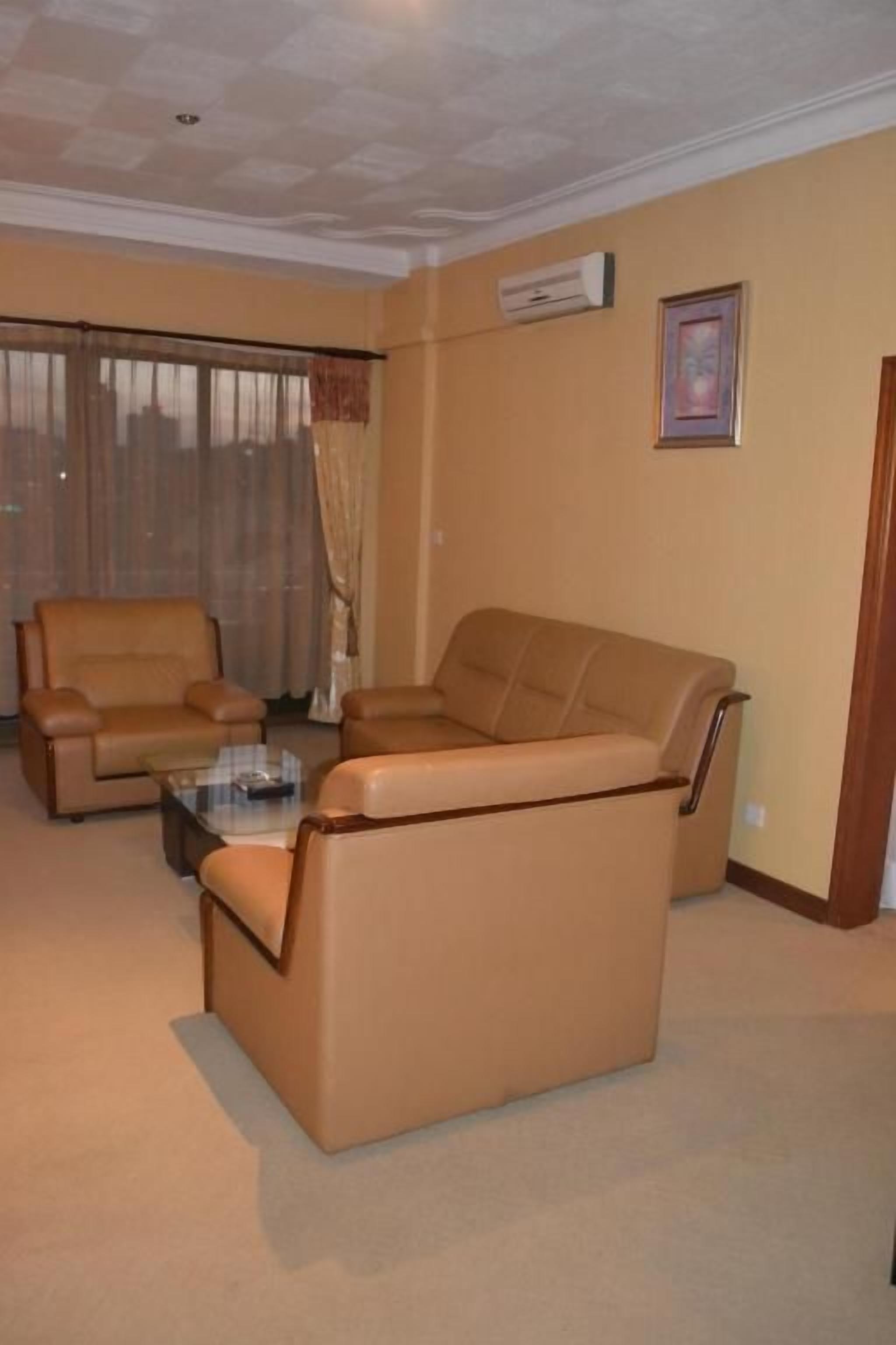 A living room with a sofa, armchair, and coffee table.