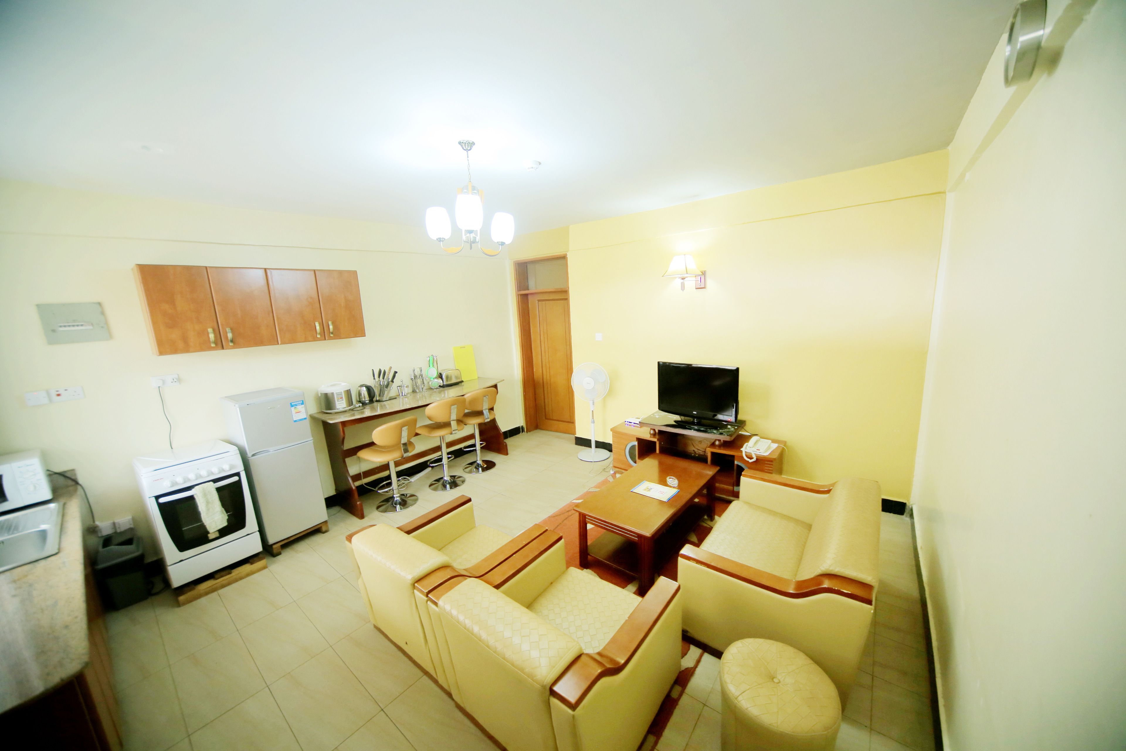 A compact living space with a kitchenette, a dining area, and a seating area.