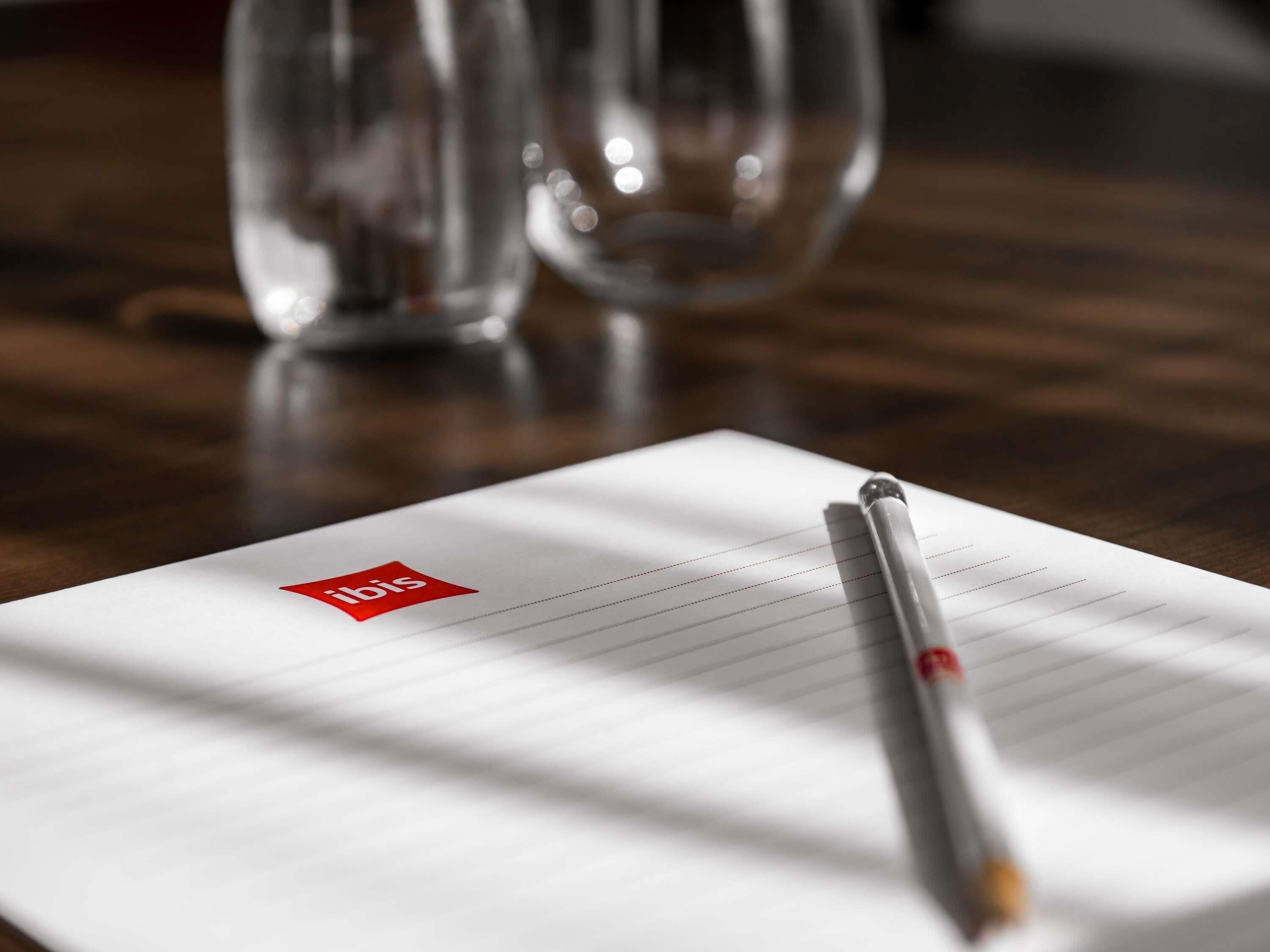 A notebook with a red logo on a wooden surface.
