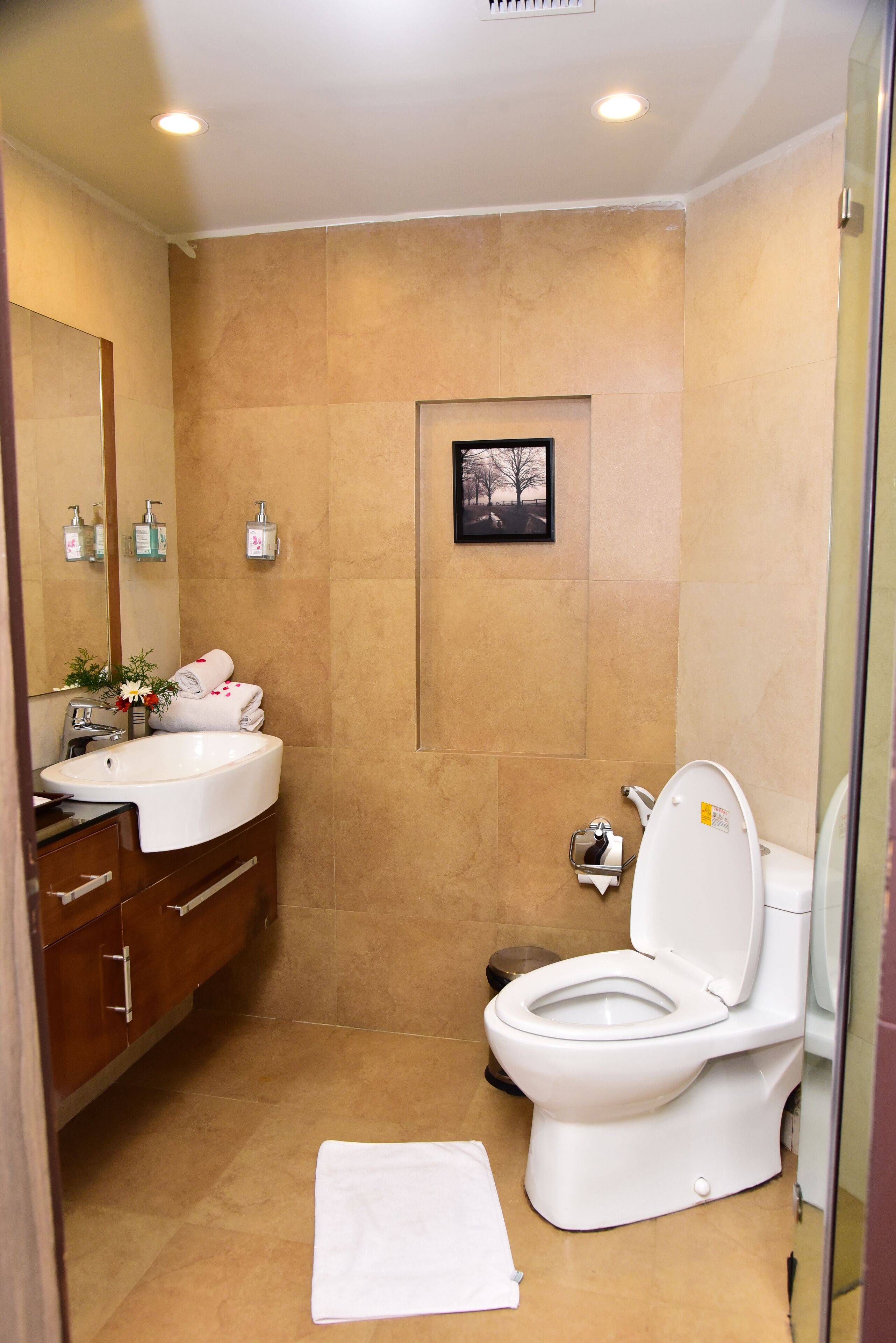 A bathroom with a white sink, a toilet, and a shower area.