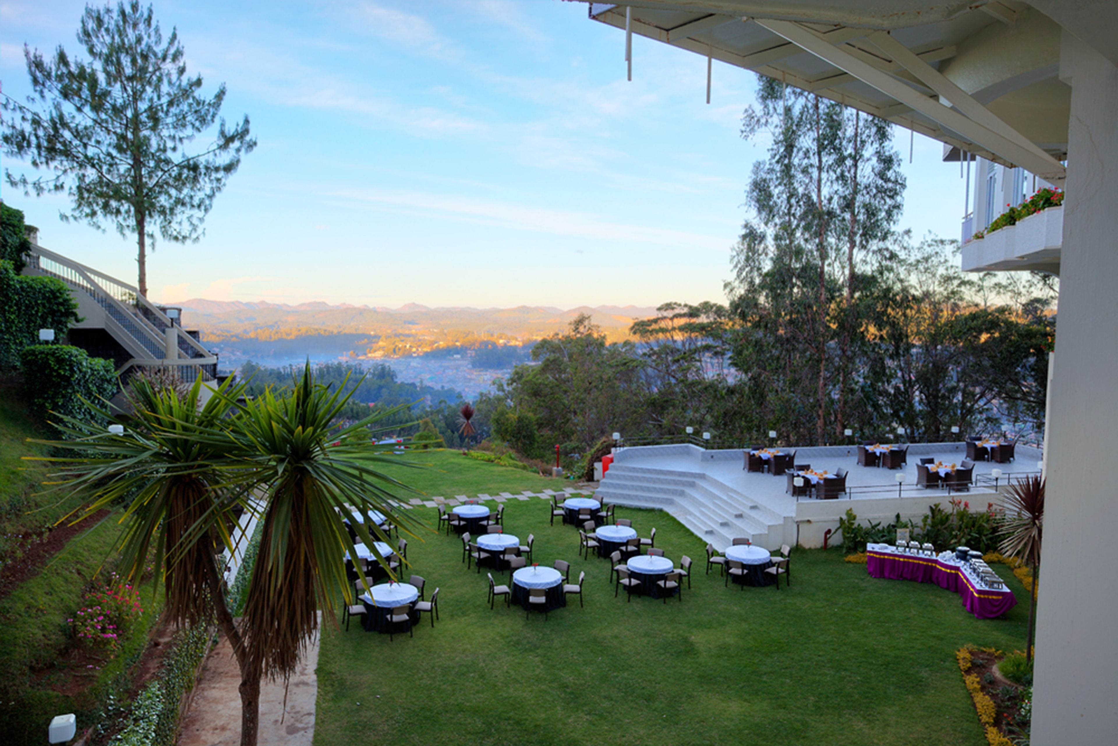 A terrace with outdoor seating and a view of the mountains.