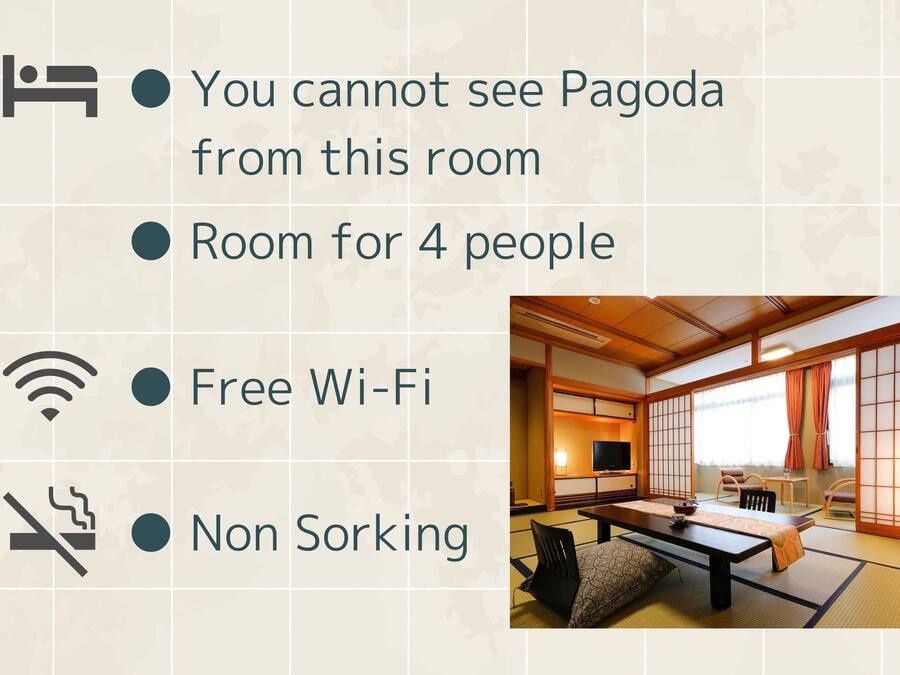 A traditional Japanese room with tatami flooring, a low table, and sliding doors.