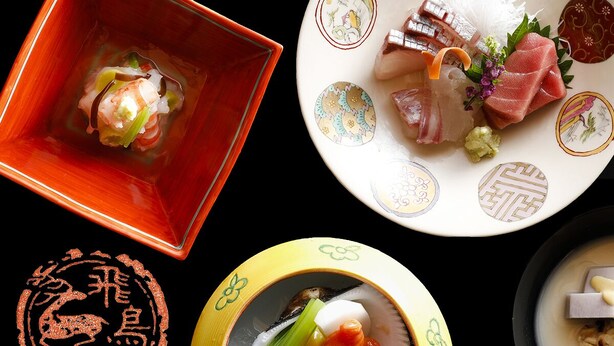 A variety of Japanese dishes, including sashimi and sushi, served on decorative plates. - Asukasou (Nara)