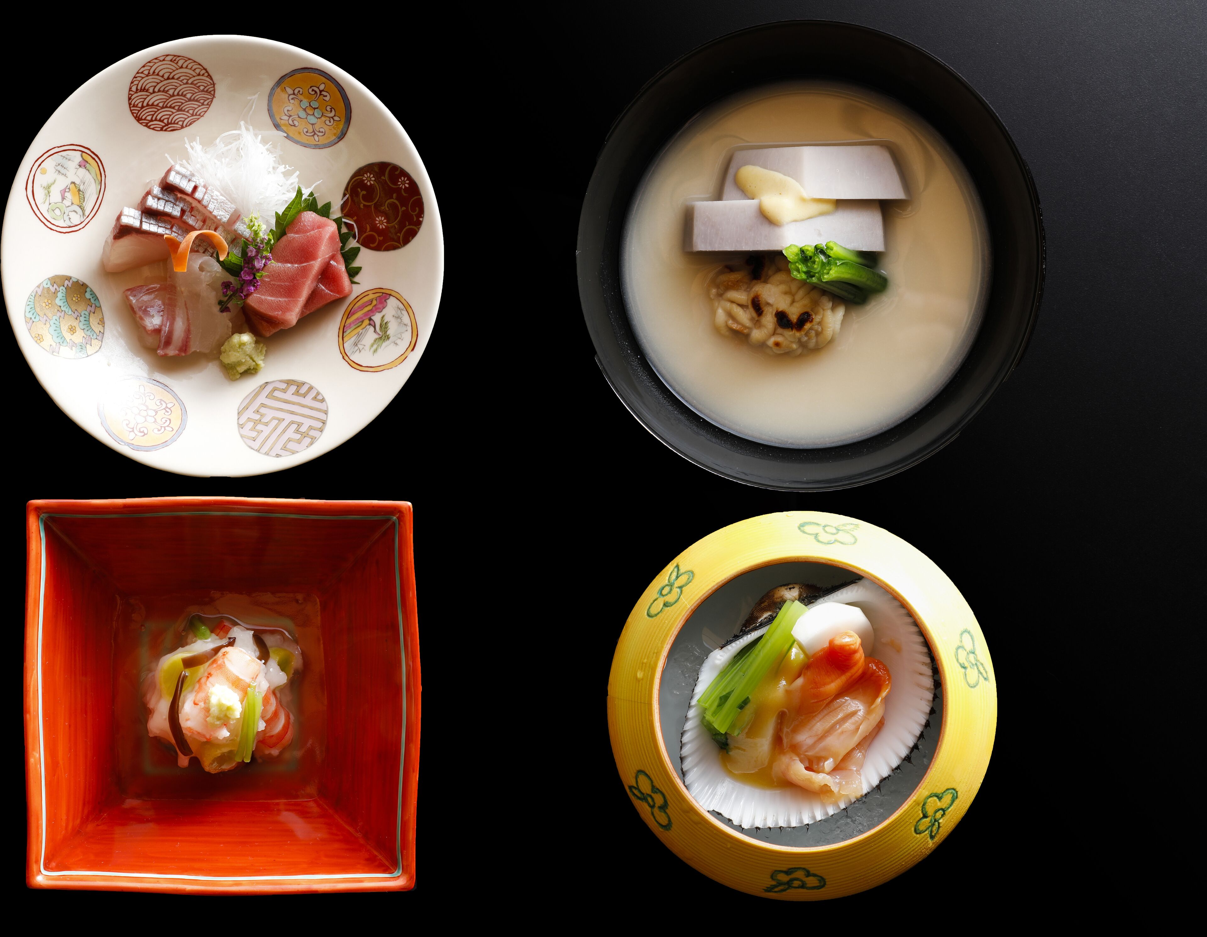 Four different Japanese dishes, each served in unique bowls.