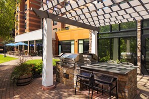 An outdoor patio area with a grill and seating. - Homewood Suites by Hilton St Louis Park at West End (St. Louis Park)