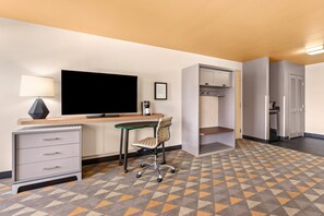 A hotel room with a desk, chair, television, and wardrobe. - Holiday Inn Yakima by IHG (Yakima)