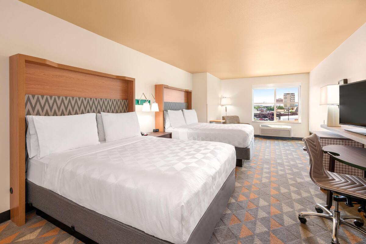 Premium bedding, desk, laptop workspace, blackout drapes