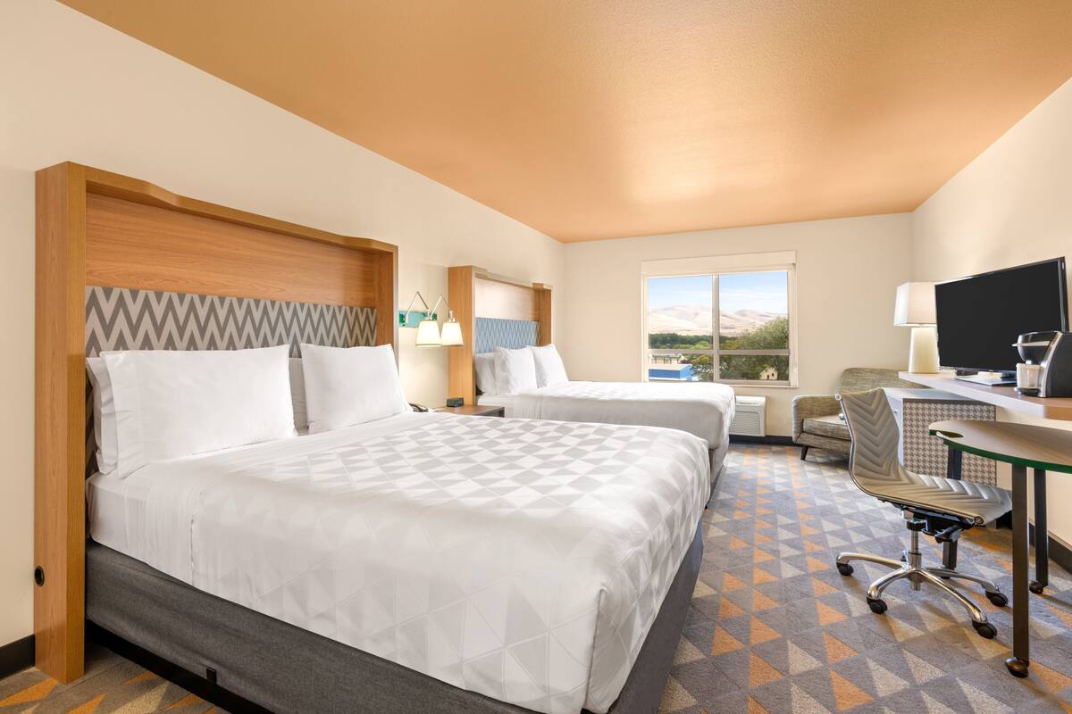 Premium bedding, desk, laptop workspace, blackout drapes
