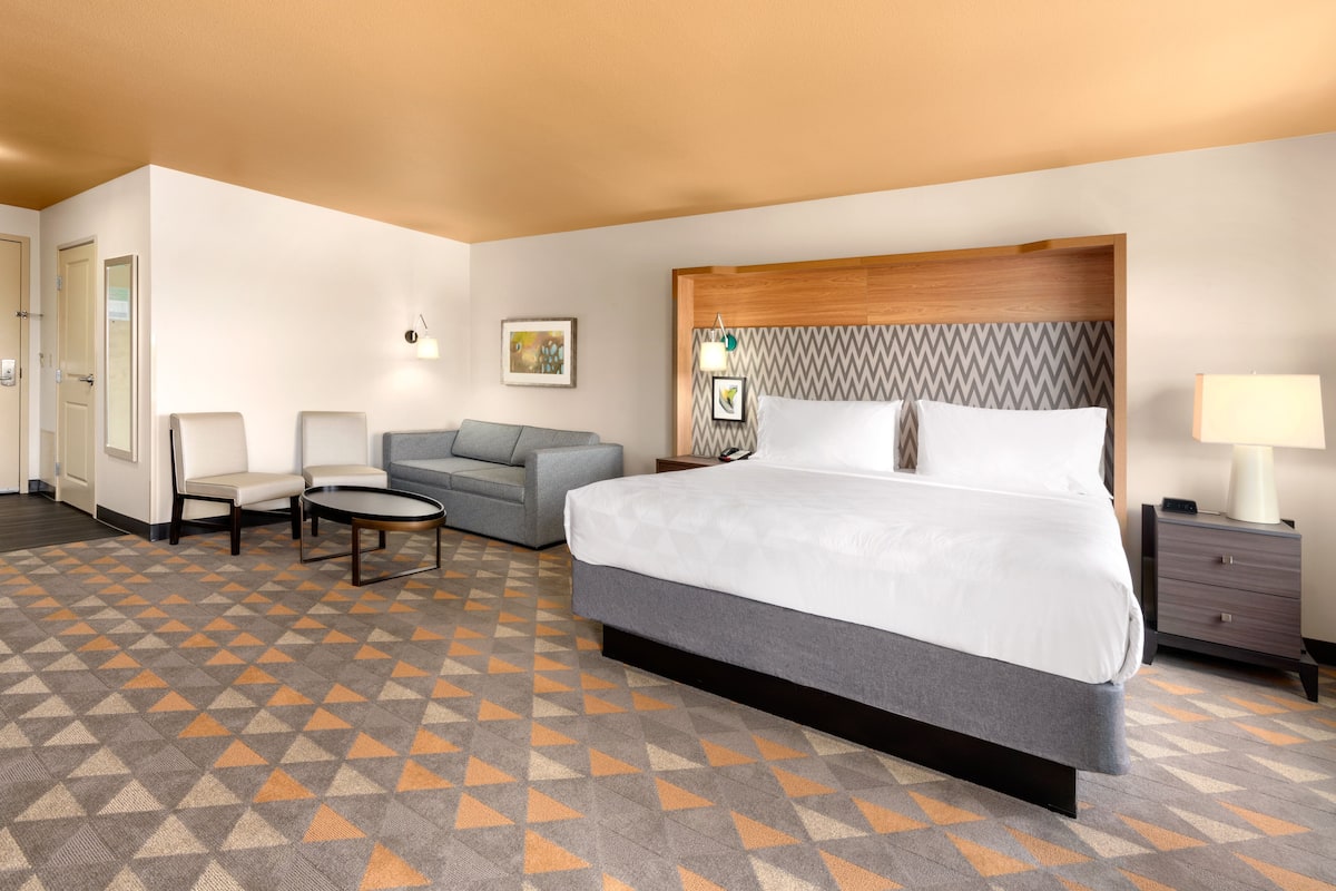 Premium bedding, desk, laptop workspace, blackout drapes