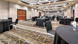 A conference room with multiple tables, chairs, and a patterned carpet. - Holiday Inn Yakima by IHG (Yakima)