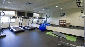 A gym with treadmills, exercise balls, and a bench. - Holiday Inn Express Hotel & Suites Rogers by IHG (Rogers)