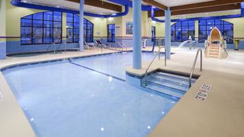 Swimmers can enjoy a rectangular pool surrounded by a tiled deck with multiple lanes.