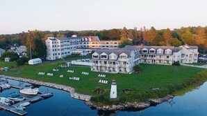A large, multi-story hotel with a central courtyard and a marina. - Nonantum Resort (Kennebunkport)