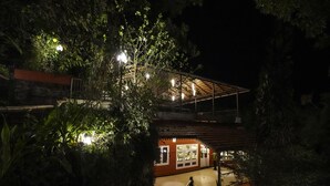 A two-story building with a covered outdoor area and a staircase leading to the upper level. - Tea Valley Resort (Devikolam)