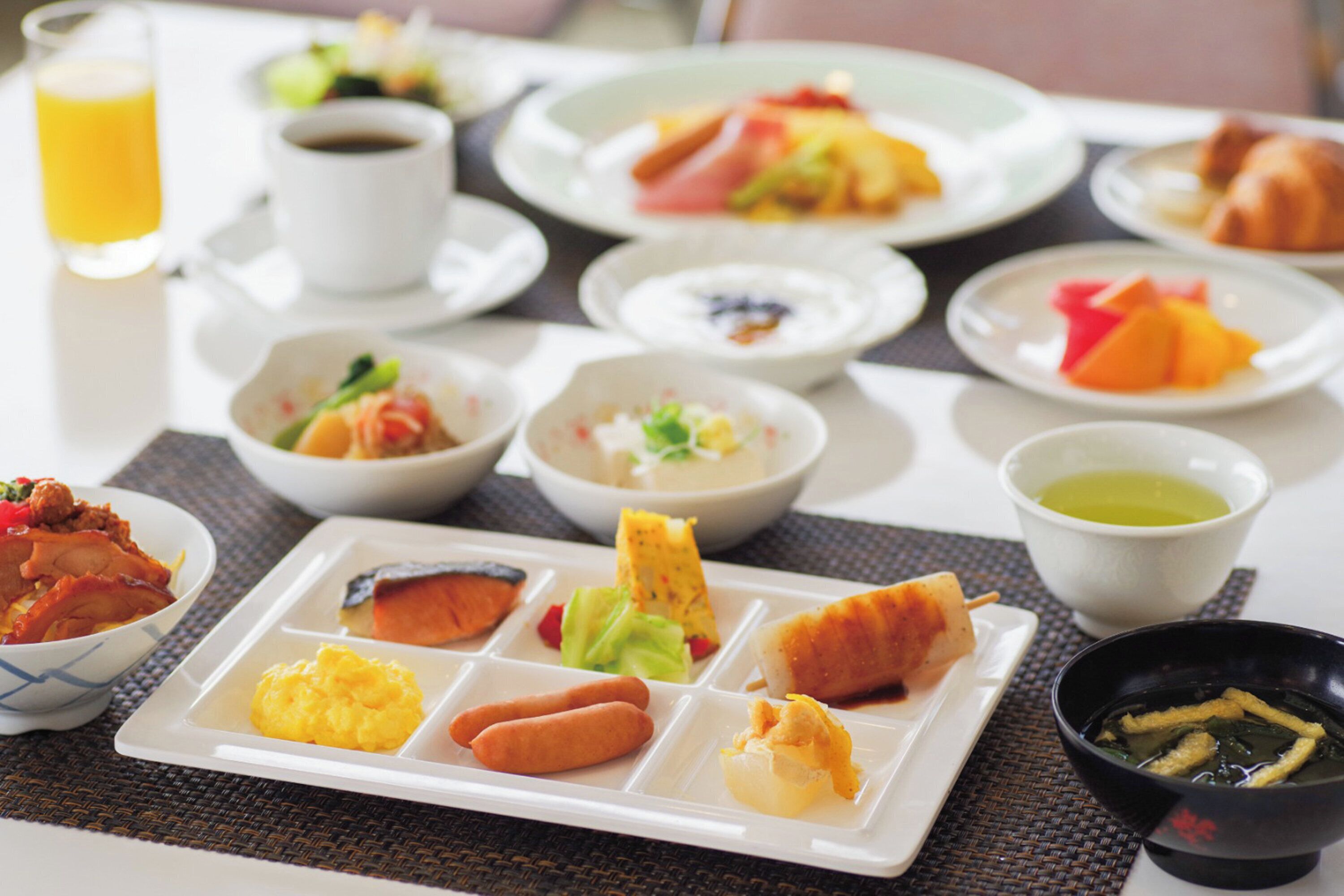 A breakfast buffet with various dishes and beverages.