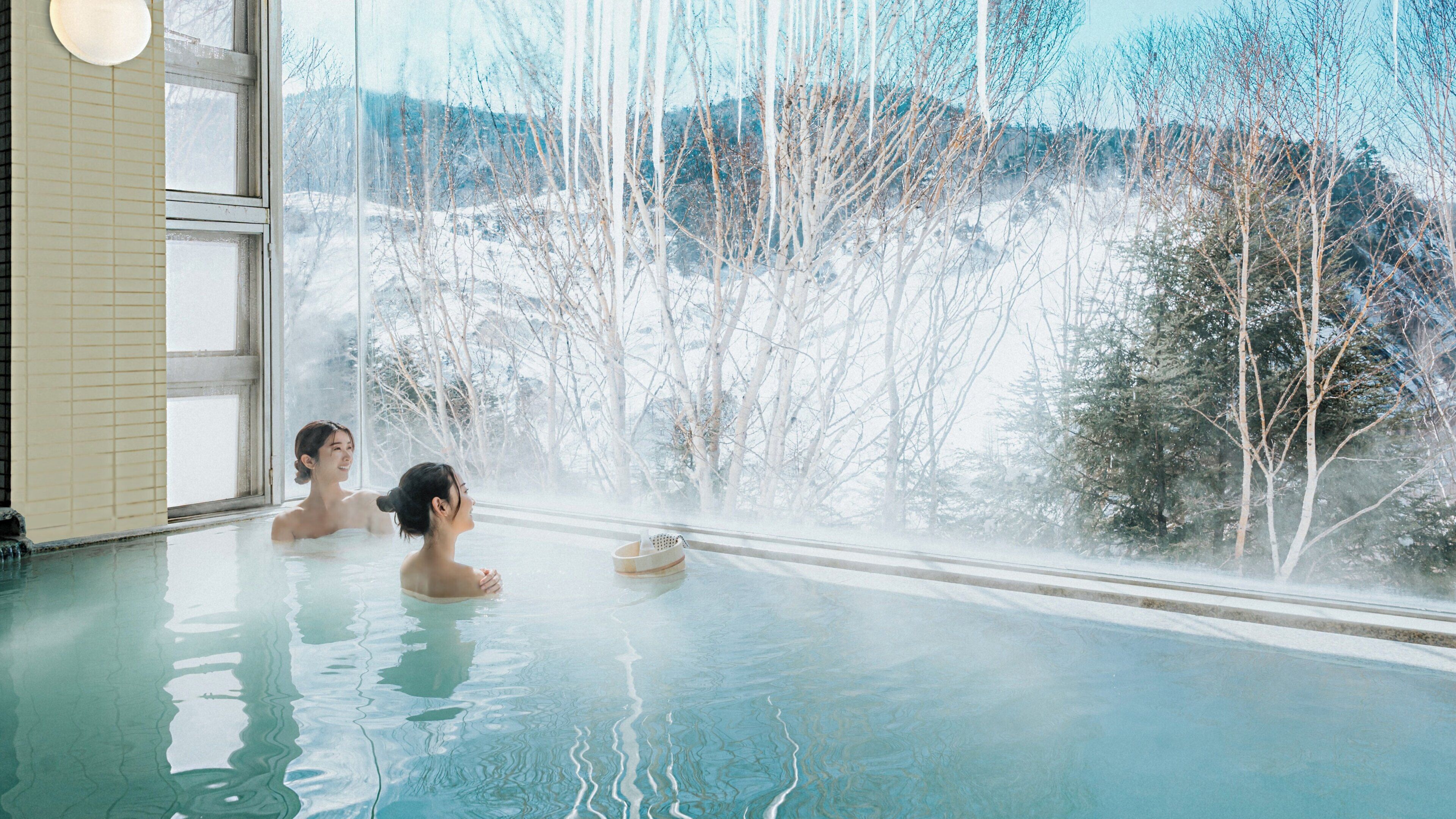 A hot tub with a view of a snowy landscape.