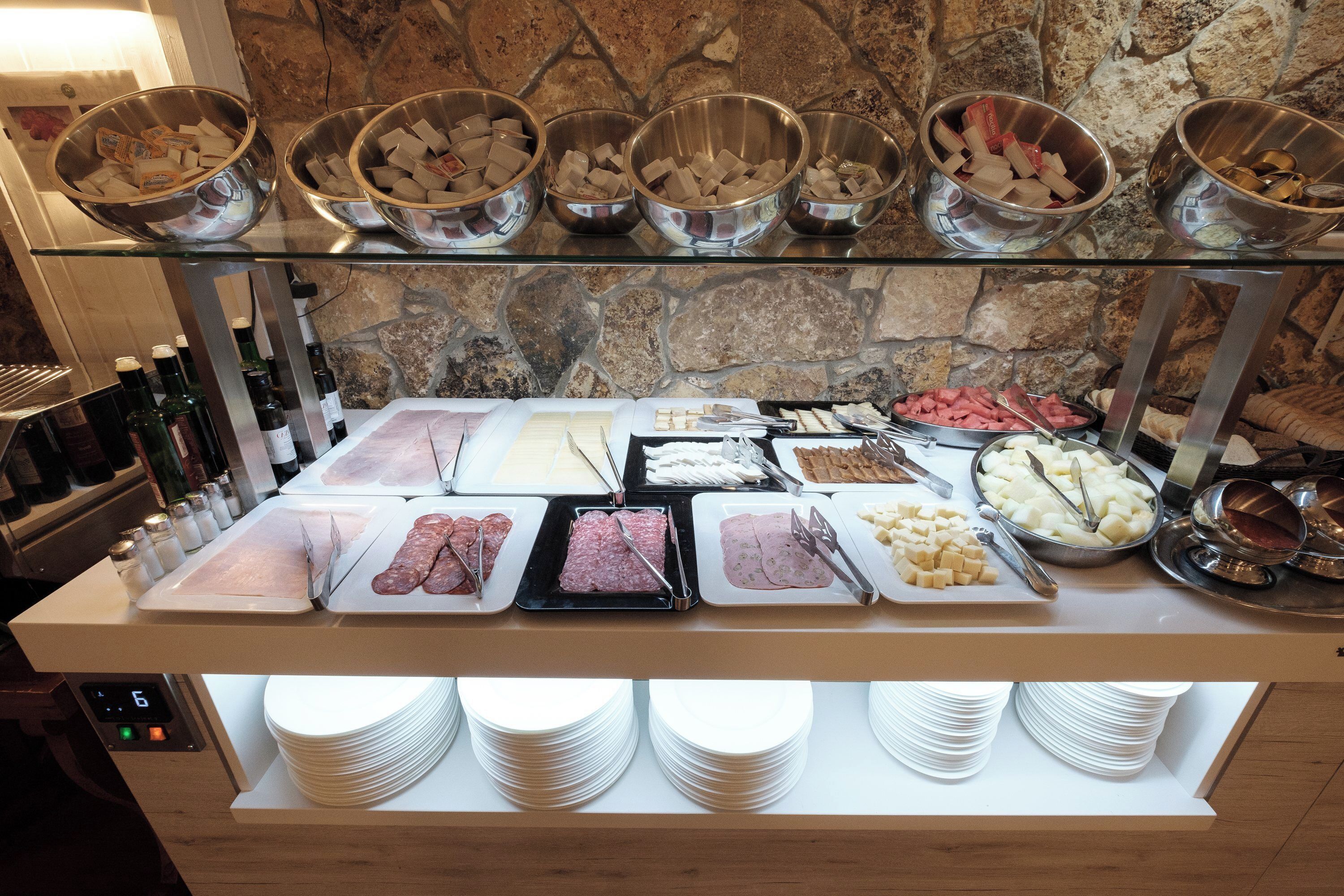 A buffet with various food items and condiments.