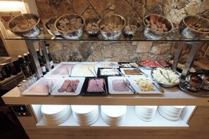 A buffet with various food items and condiments.