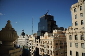 A cityscape with historic buildings and a modern skyscraper. - Hostal Luis XV (Madrid)