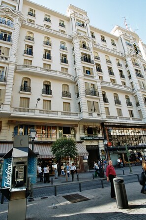 Ein mehrstöckiges Hotel im klassischen Stil, mit Balkonen und großen Fenstern.
