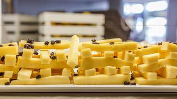 A plate of cheese cubes with raisins.