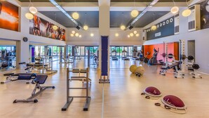 A gym with various exercise equipment, large windows, and a mirrored wall. - Kipriotis Aqualand by Anayia All Inclusive Resorts (Kos)