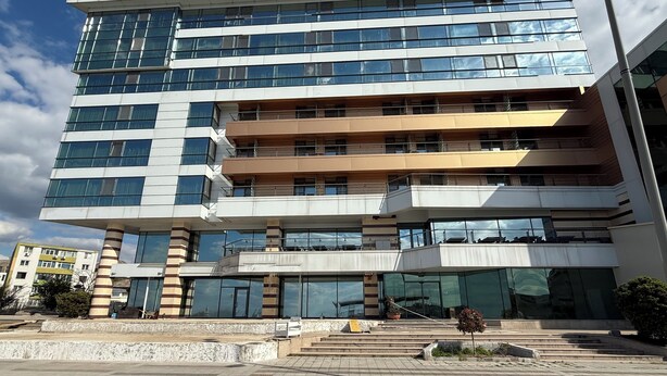 A multi-story hotel with a modern design, featuring large windows and a prominent 'HOTEL DELTA' sign.