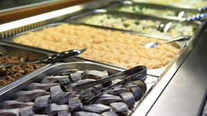 A buffet with various food items, including fish, salads, and other dishes.